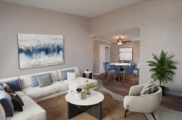 Martinez apartment for rent - A living room with a white couch, a coffee table, a chair, and a painting on the wall.