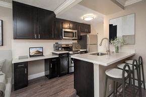 San Francisco apartment for rent - a kitchen with black cabinets and a white counter top