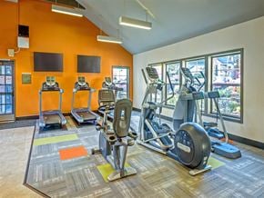 Renton apartment for rent - A gym with orange walls and a variety of exercise equipment.