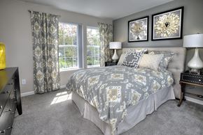 Vancouver apartment for rent - A bedroom with a large bed and two wall lamps.