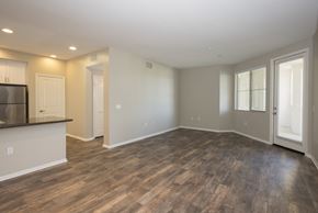 Monrovia apartment for rent - A spacious room with wooden flooring and white walls.