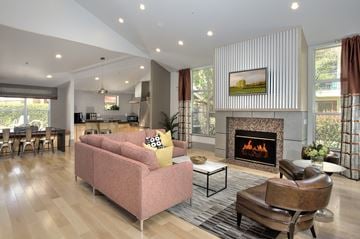 Petaluma apartment for rent - A living room with a pink couch and a fireplace.