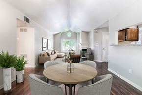 Sacramento apartment for rent - A dining room with a round table surrounded by grey chairs.