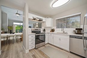 Sacramento apartment for rent - A modern kitchen with white cabinets and stainless steel appliances.