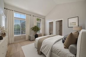 Sacramento apartment for rent - A bedroom with a large bed and a window with blinds.