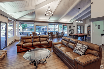 Concord apartment for rent - A living room with a brown leather couch and a glass coffee table.