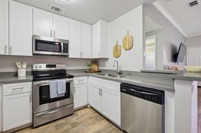 Foothill Ranch apartment for rent - A kitchen with white cabinets and stainless steel appliances.