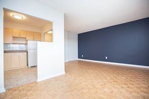 Winnipeg apartment for rent - an empty living room and kitchen with a wood floor
