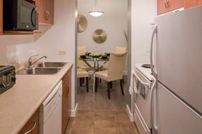 Winnipeg apartment for rent - A kitchen with a table and chairs in the middle.
