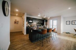 Winnipeg apartment for rent - a kitchen with a bar and chairs in a room
