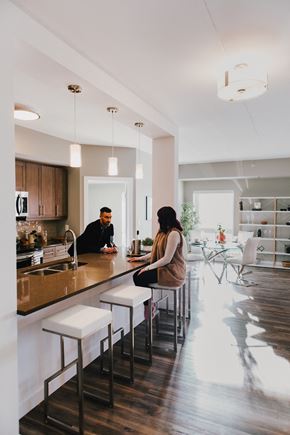 Winnipeg apartment for rent - a man and woman sitting at a counter in a kitchen