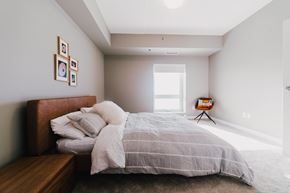 Winnipeg apartment for rent - a bedroom with a bed and a large window