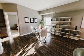 Winnipeg apartment for rent - a dining room with a table and chairs and a book shelf