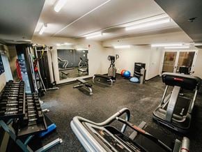 Winnipeg apartment for rent - a gym with treadmills and other exercise equipment in a home gym