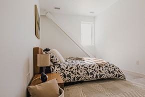 Winnipeg apartment for rent - a bedroom with a bed next to a staircase