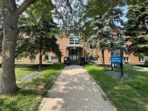 Winnipeg apartment for rent - a brick building with trees in front of it