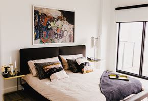 Winnipeg apartment for rent - a bedroom with a bed and a painting on the wall