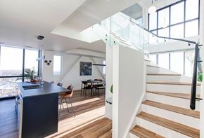 Winnipeg apartment for rent - a living room with a staircase and a table and a kitchen