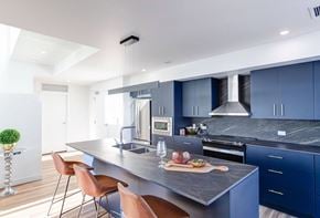Winnipeg apartment for rent - a kitchen with blue cabinets and a marble counter top