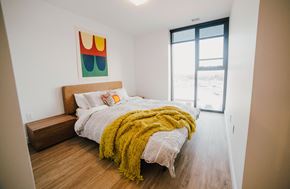 Winnipeg apartment for rent - a bedroom with a bed and a large window