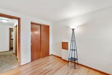 Wauwatosa apartment for rent - a living room with a tripod lamp and a door to a bedroom
