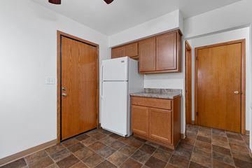 Milwaukee apartment for rent - a kitchen with a refrigerator and cabinets and a door