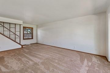 Glendale apartment for rent - a living room with white walls and carpet and a staircase