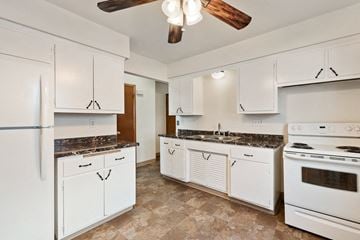 Milwaukee apartment for rent - a kitchen with white appliances and white cabinets