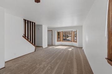 Milwaukee apartment for rent - a living room with white walls and carpet and a window