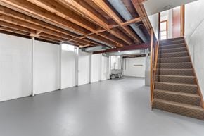 Milwaukee triplex for rent - A room with a staircase and a white wall.