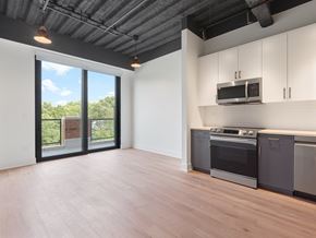 Chicago apartment for rent - A kitchen with a stove top oven and microwave.