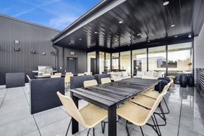 Chicago apartment for rent - A modern outdoor dining area with a long table and chairs.