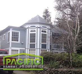 Ashland apartment for rent - a gray house with a gray roof and a sign for pacific rental properties
