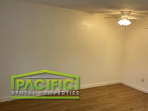 Ashland apartment for rent - a living room with a ceiling fan and a sign on the wall
