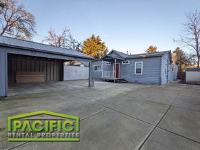 Medford apartment for rent - a blue house with a driveway and a garage