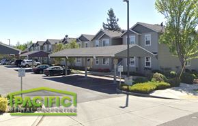 Medford apartment for rent - a parking lot in front of a row of houses