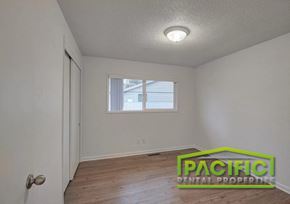 Eagle Point apartment for rent - A room with a window and a door is shown with a logo for Pacific Rental Properties.