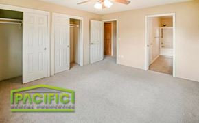 Medford apartment for rent - a empty living room with white doors and a ceiling fan