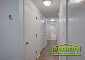 Eagle Point apartment for rent - A hallway with doors on both sides and a logo in the middle.