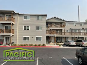 Medford apartment for rent - an apartment building with cars parked in a parking lot