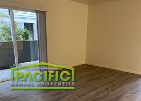 Medford apartment for rent - an empty living room with a window and wooden floors
