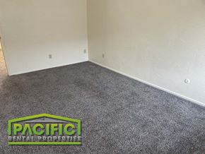 Ashland apartment for rent - a carpeted room with a pacitech logo on the floor