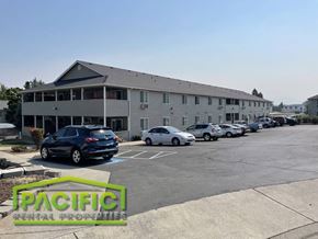 Central Point apartment for rent - a parking lot with cars in front of a building