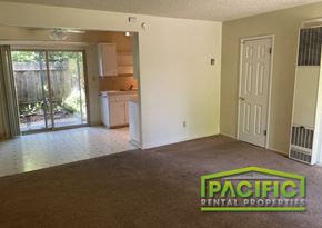 Ashland apartment for rent - an empty living room with a door to a kitchen
