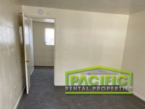Ashland apartment for rent - a corridor with a pacific rental properties logo on the wall