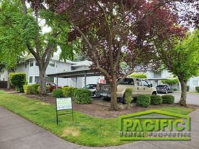 Medford apartment for rent - an apartment building with a parking lot and trees