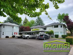 Medford apartment for rent - a suburban house with a parking lot and cars in front of it
