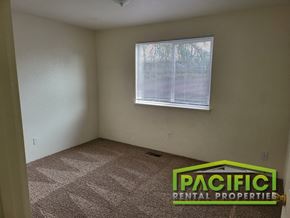 Medford apartment for rent - an empty room with a window and a carpeted floor