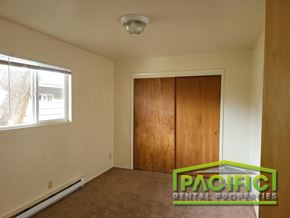 Medford apartment for rent - a bedroom with a wardrobe and a window and a carpeted floor