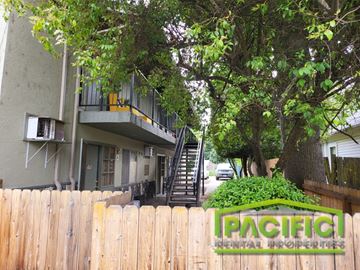Medford apartment for rent - an apartment building with stairs and a fence